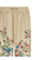 Flora and fauna printed trousers Beige