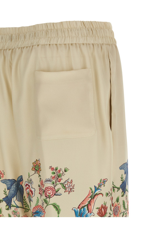 Flora and fauna printed trousers Beige